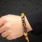 Three-Eyed Dzi Tibetan Cow Bone Strings Agate Playing with Discs Holding Tiger Teeth Bracelets for Men and Women-11